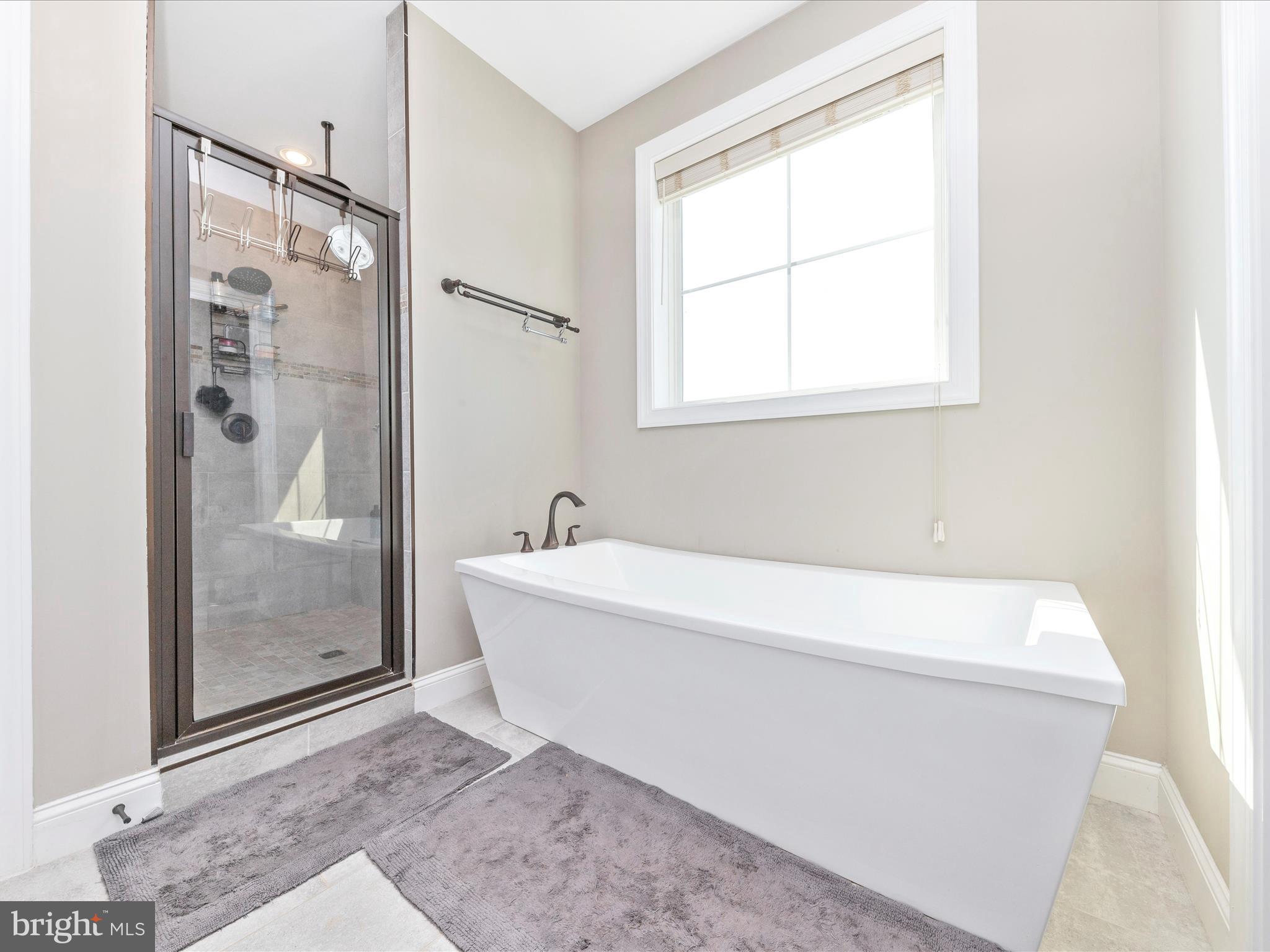 14671 Sugarland Road Poolesville, MD 20837 - Photo 26 of 62 a bathroom with a bathtub and shower