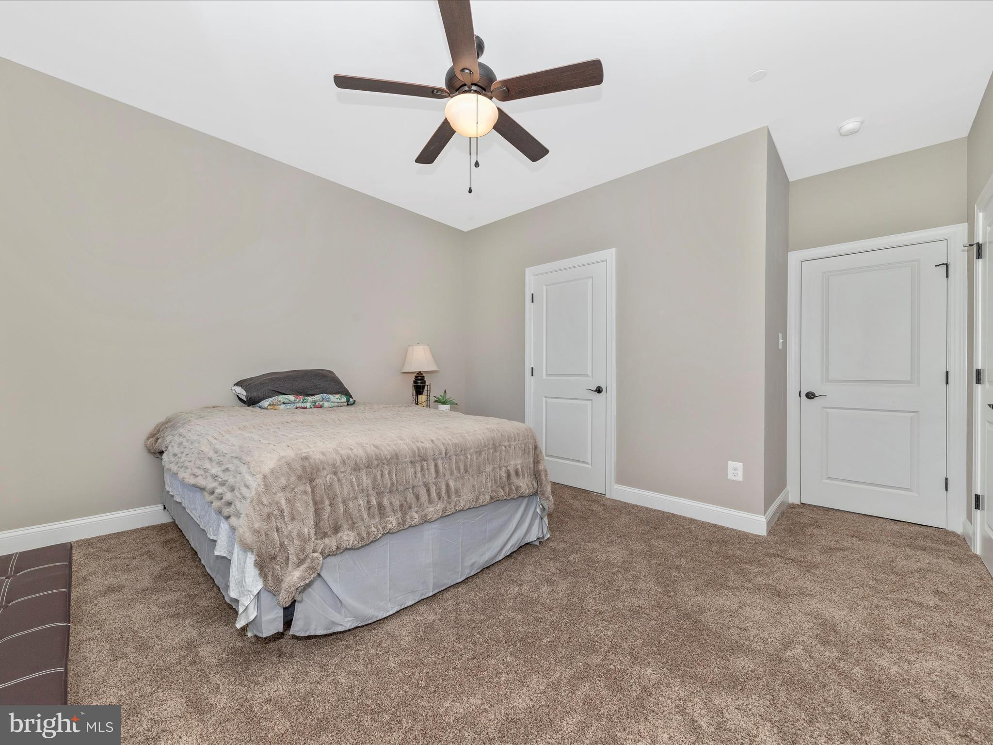 14671 Sugarland Road Poolesville, MD 20837 - Photo 28 of 62 a bedroom with a bed and a ceiling fan