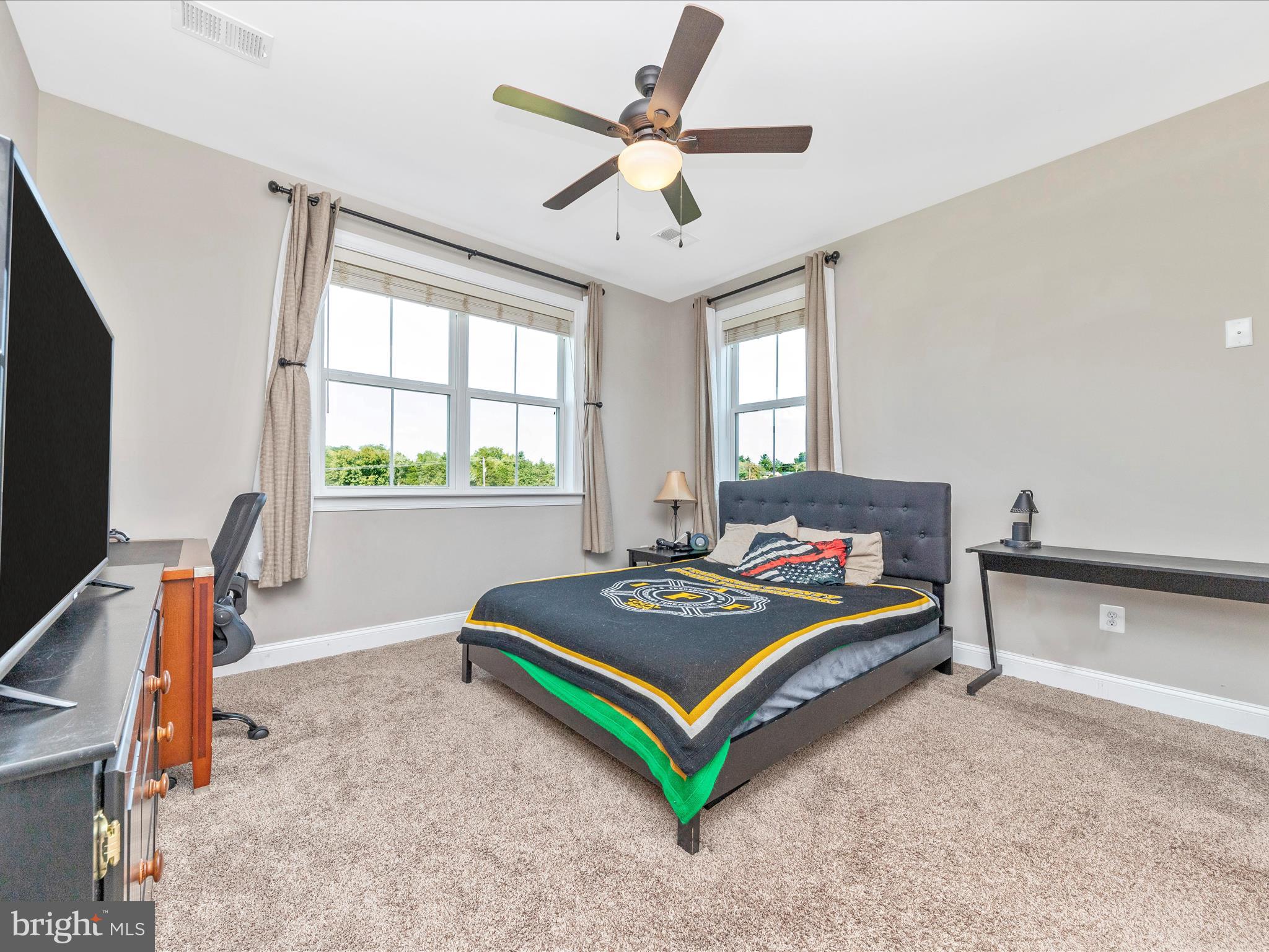 14671 Sugarland Road Poolesville, MD 20837 - Photo 35 of 62 a living room with furniture a flat screen tv and a window