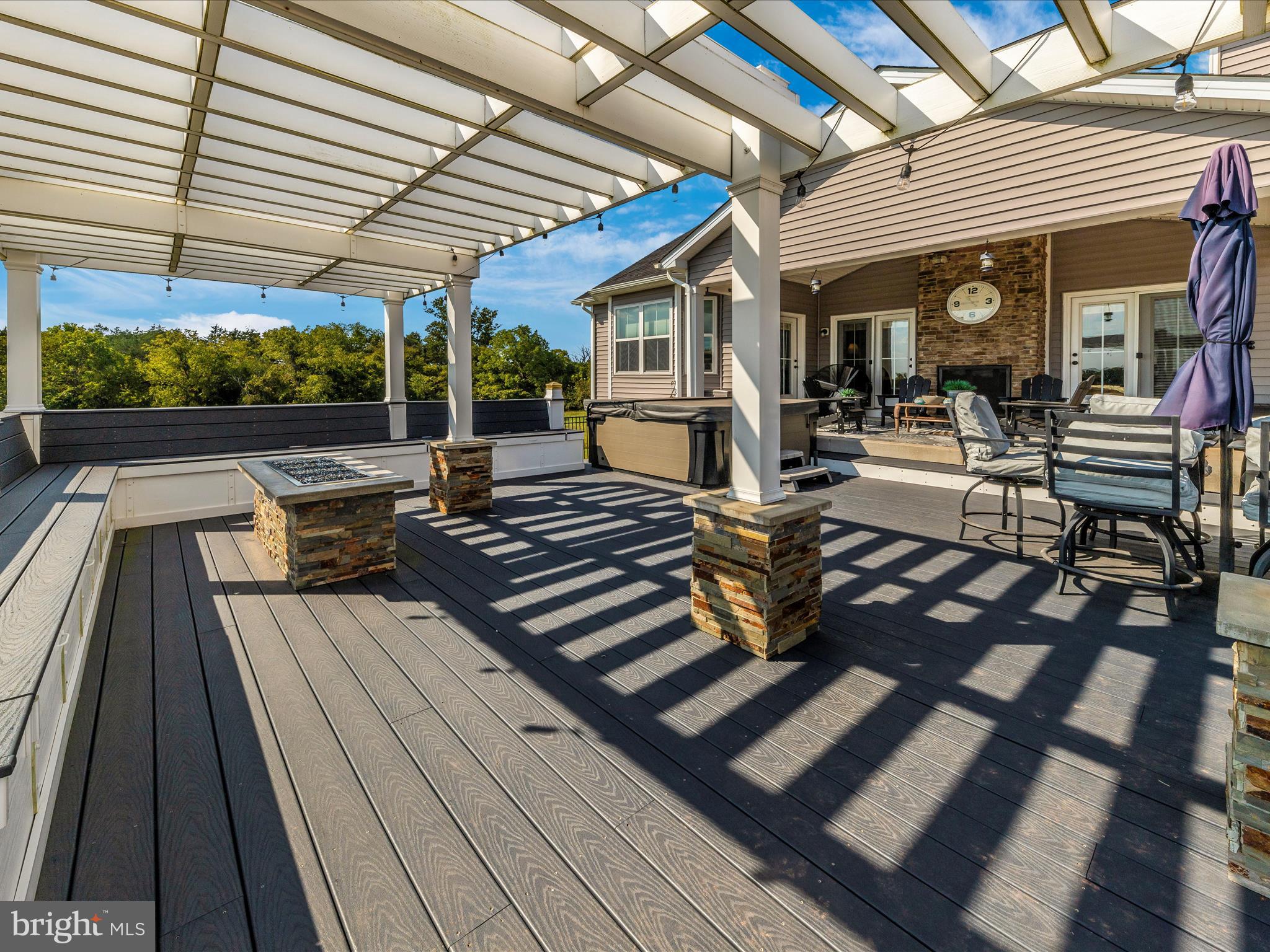 14671 Sugarland Road Poolesville, MD 20837 - Photo 48 of 62 a view of a patio with table and chairs and wooden floor