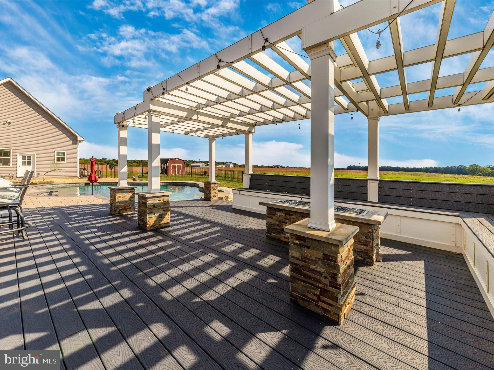 14671 Sugarland Road Poolesville, MD 20837 - Photo 49 of 62 a view of a patio with table and chairs with wooden floor and fence