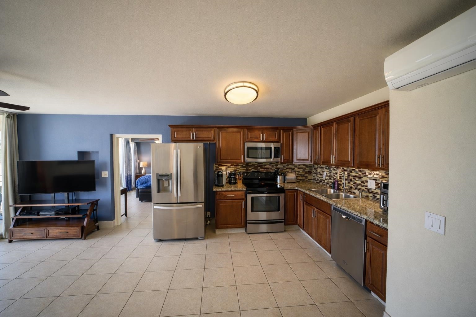 1993 South Kihei Road, Unit 201 Kihei, HI 96753 - Photo 7 of 11 a large kitchen with cabinets and stainless steel appliances