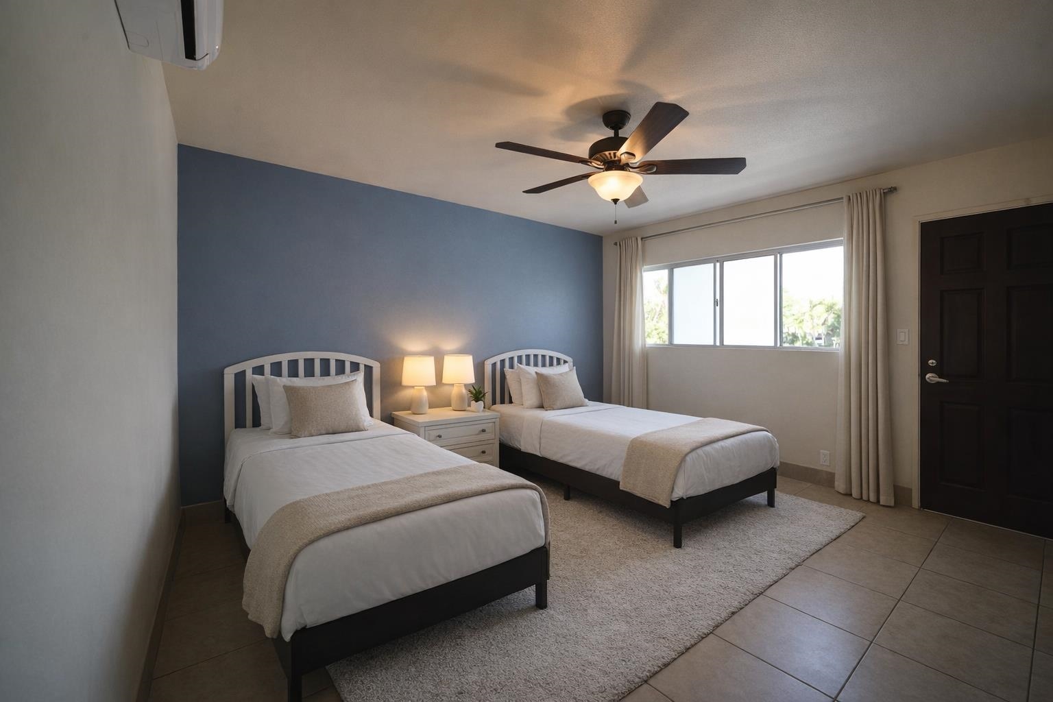 1993 South Kihei Road, Unit 201 Kihei, HI 96753 - Photo 8 of 11 a bedroom with two beds and a chandelier