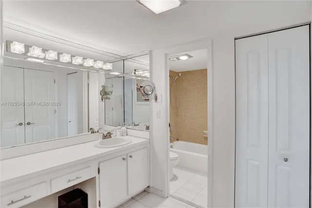 a bathroom with a double vanity sink mirror and shower