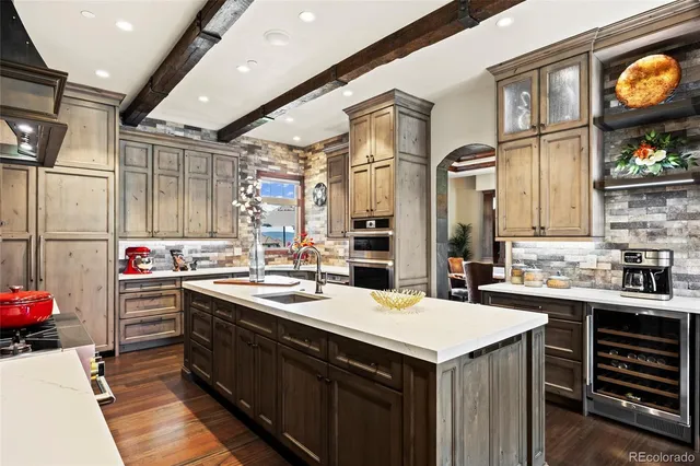 a kitchen that has a sink a stove and a wooden cabinets