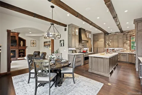 a large kitchen with a table and chairs