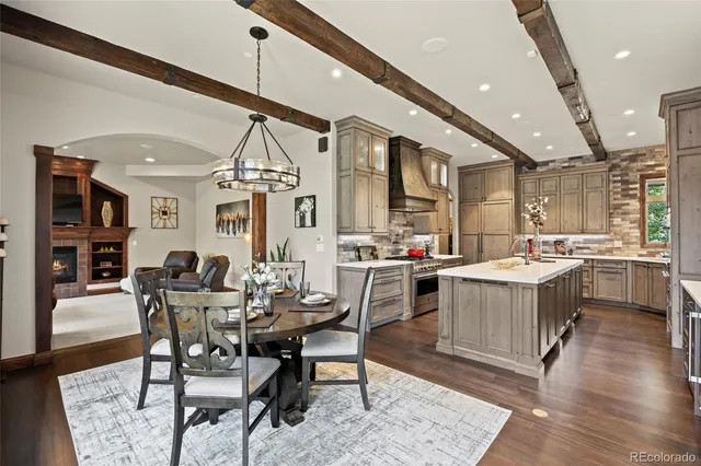 a large kitchen with a table and chairs