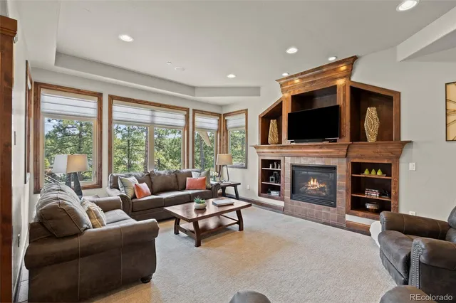 a living room with furniture a fireplace and a flat screen tv
