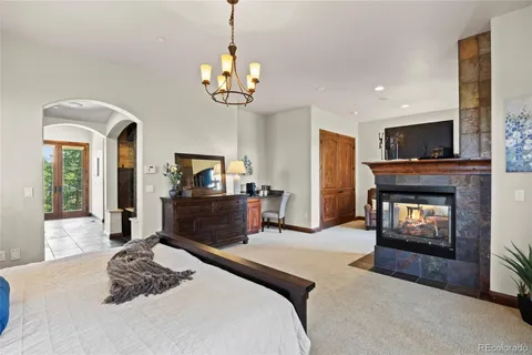 a bedroom with a bed and a fireplace