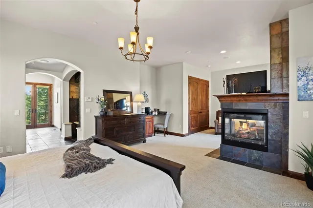 a bedroom with a bed and a fireplace