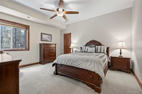 a bathroom with a granite countertop sink toilet a mirror and shower