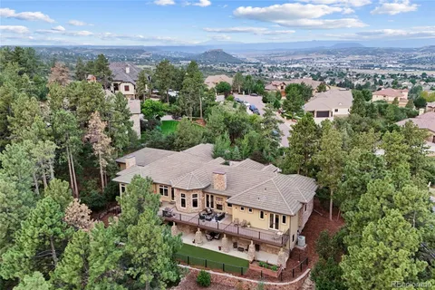 an aerial view of a house with swimming pool and furniture