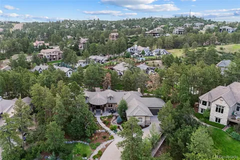 an aerial view of a house with yard and outdoor seating