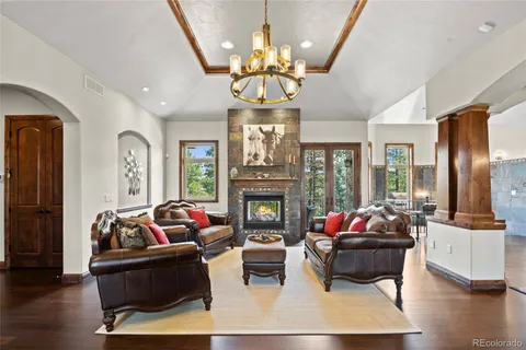 a living room with fireplace furniture or chandelier and a wooden floor