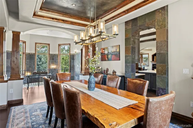 a view of a dining room with furniture wooden floor and chandelier