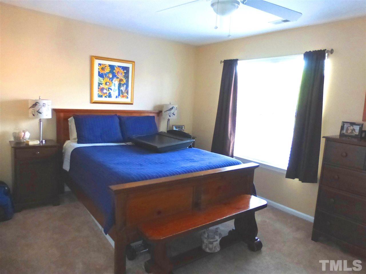 4827 Black Mountain Path Raleigh, NC 27612 - Photo 14 of 19 a bed sitting in a bedroom next to a window