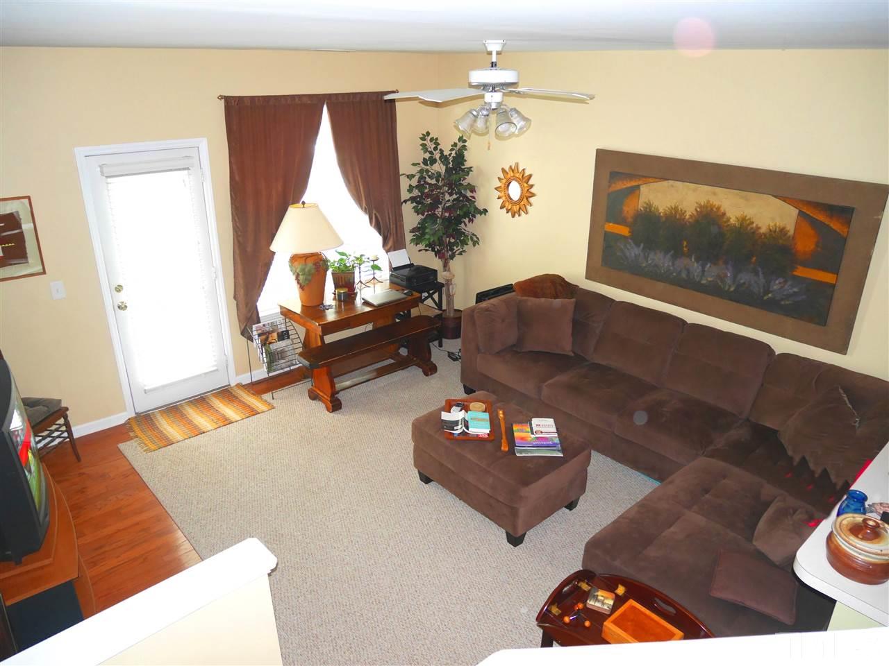 4827 Black Mountain Path Raleigh, NC 27612 - Photo 16 of 19 a living room with furniture and a flat screen tv