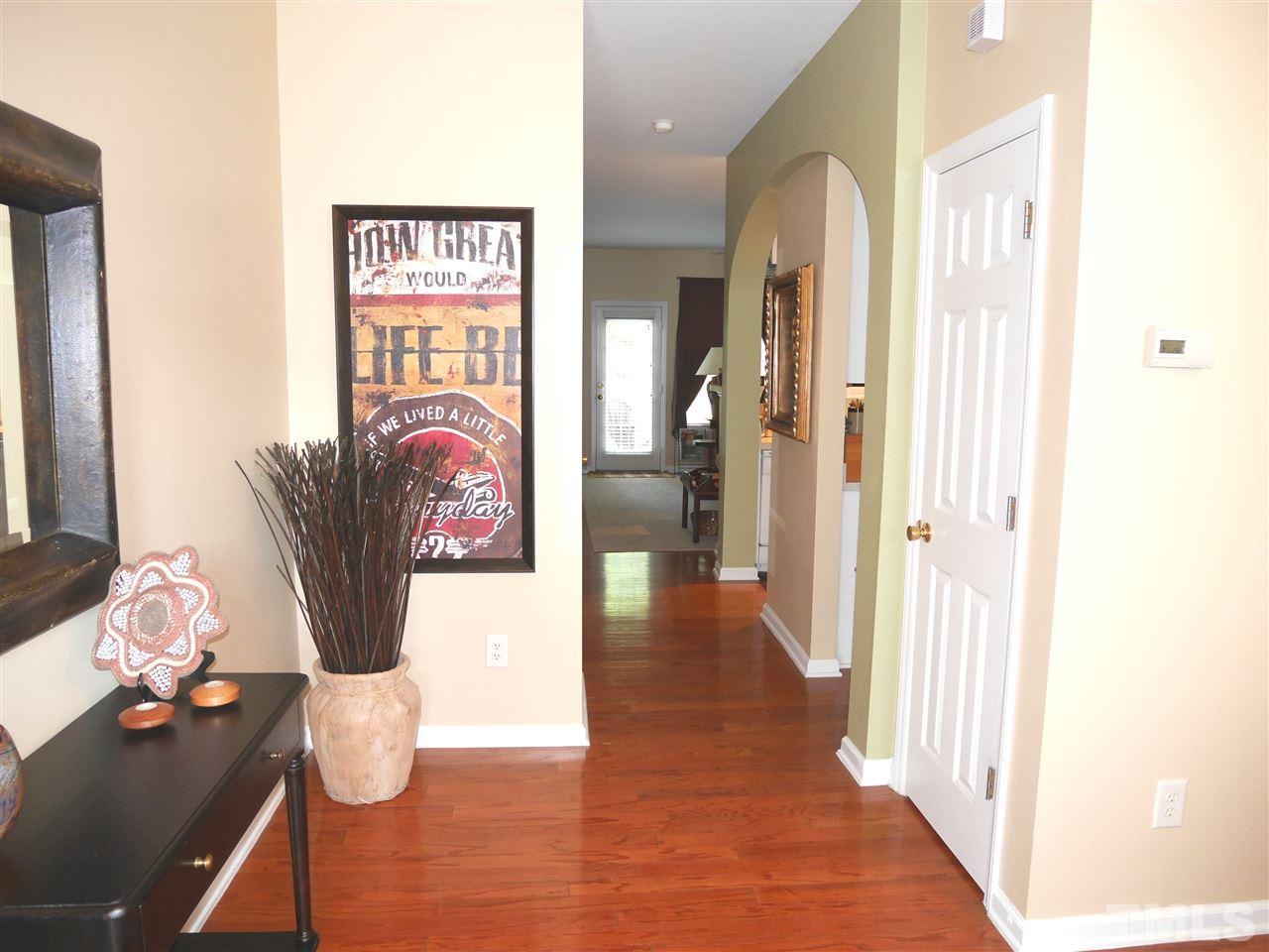 4827 Black Mountain Path Raleigh, NC 27612 - Photo 4 of 19 a hallway with furniture and wooden floor