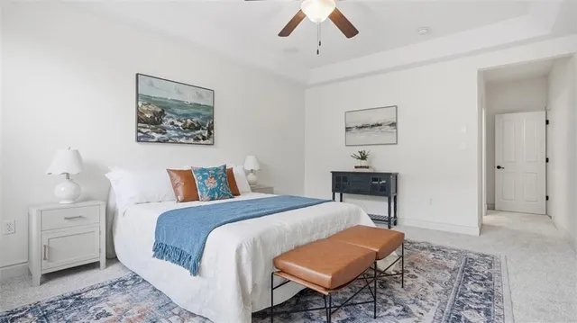 a bedroom with a bed and a lamp on table