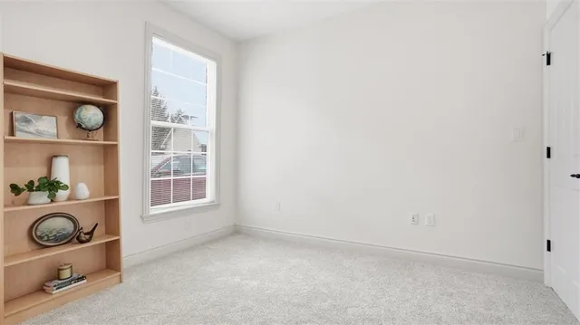 an empty room with windows and closet
