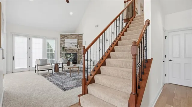 a living room with furniture and a dining table next to a window
