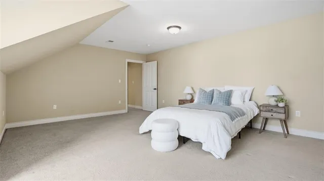 a bed room with a bed and a night stand