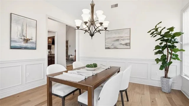 a view of a dining room with furniture wooden floor and a chandelier
