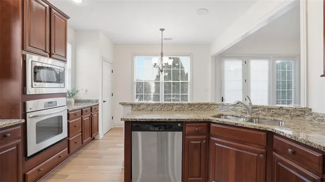 a kitchen with stainless steel appliances granite countertop a stove and a sink
