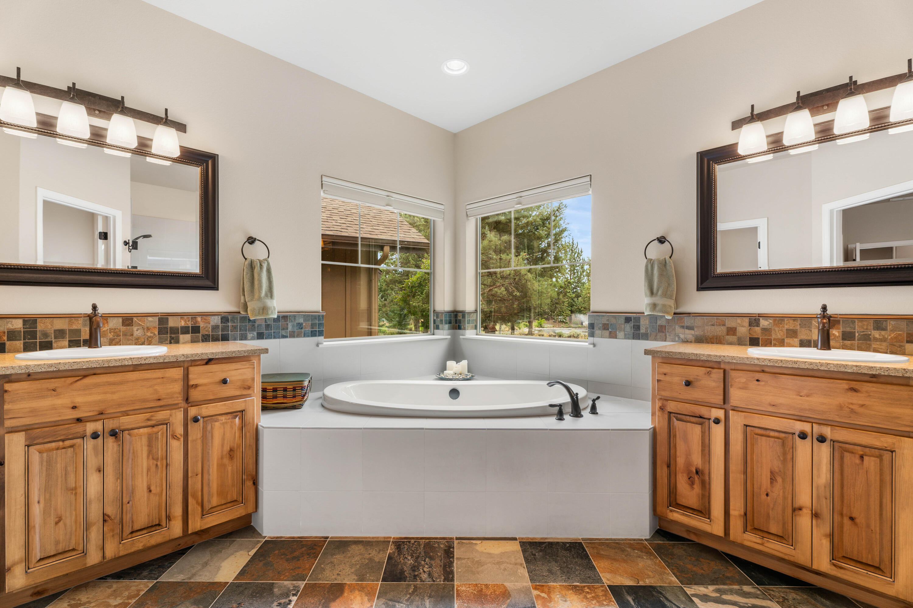 205 Vista Rim Drive Redmond, OR 97756 - Photo 26 of 85 a bathroom with a sink double vanity and a mirror
