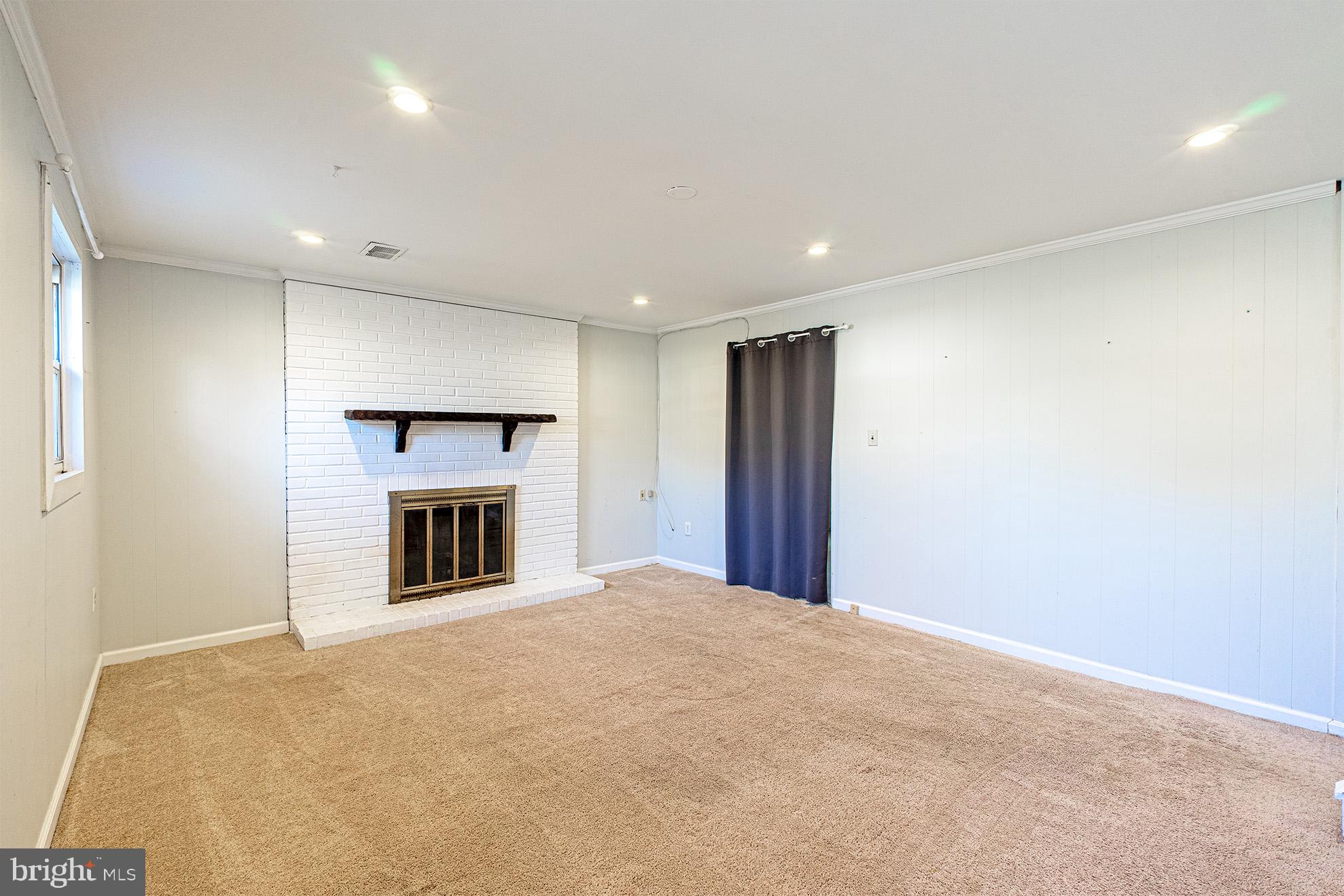8207 Old Oaks Drive Springfield, VA 22152 - Photo 13 of 19 a view of an empty room with a fireplace