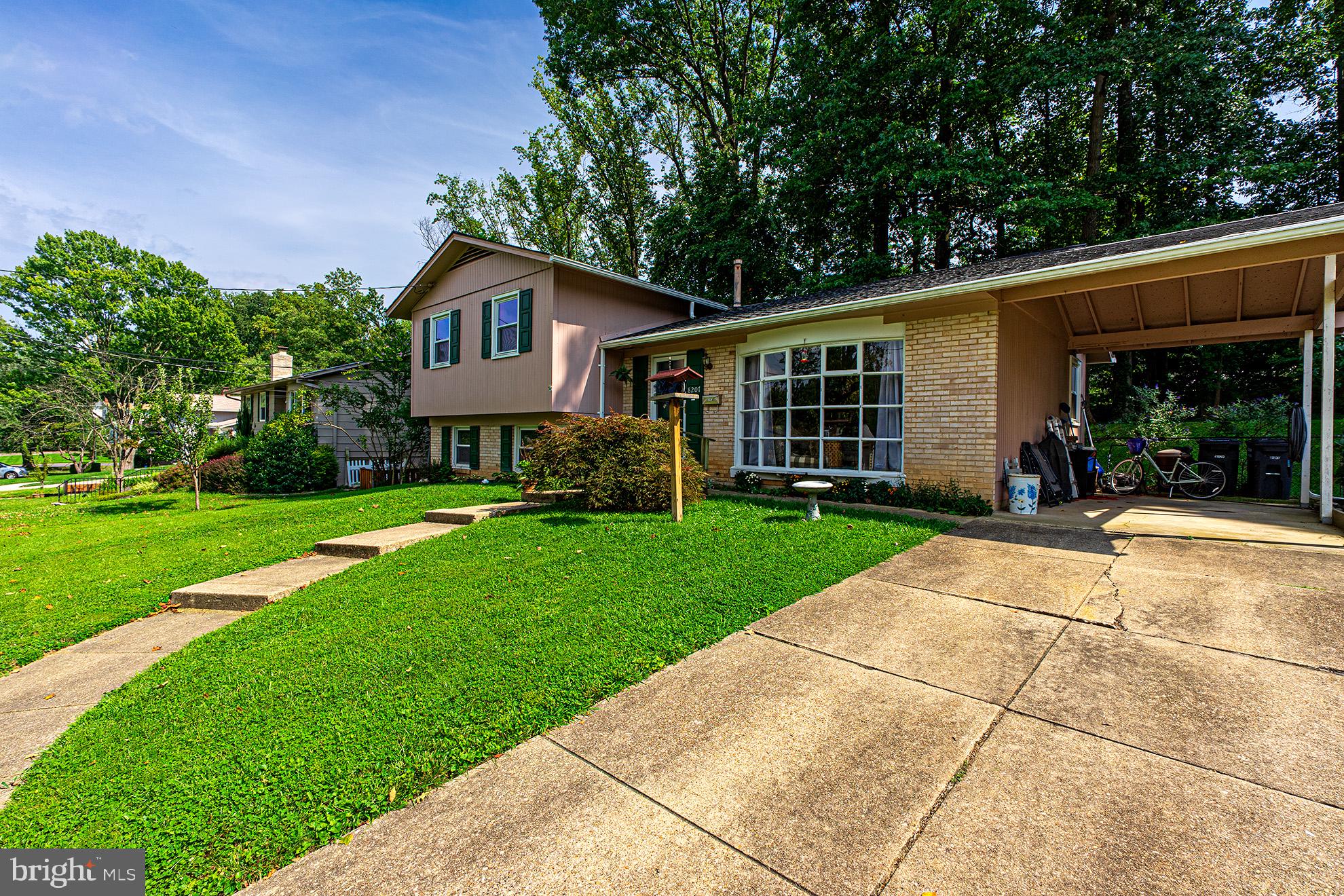 8207 Old Oaks Drive Springfield, VA 22152 - Photo 3 of 19 a front view of a house with yard and green space