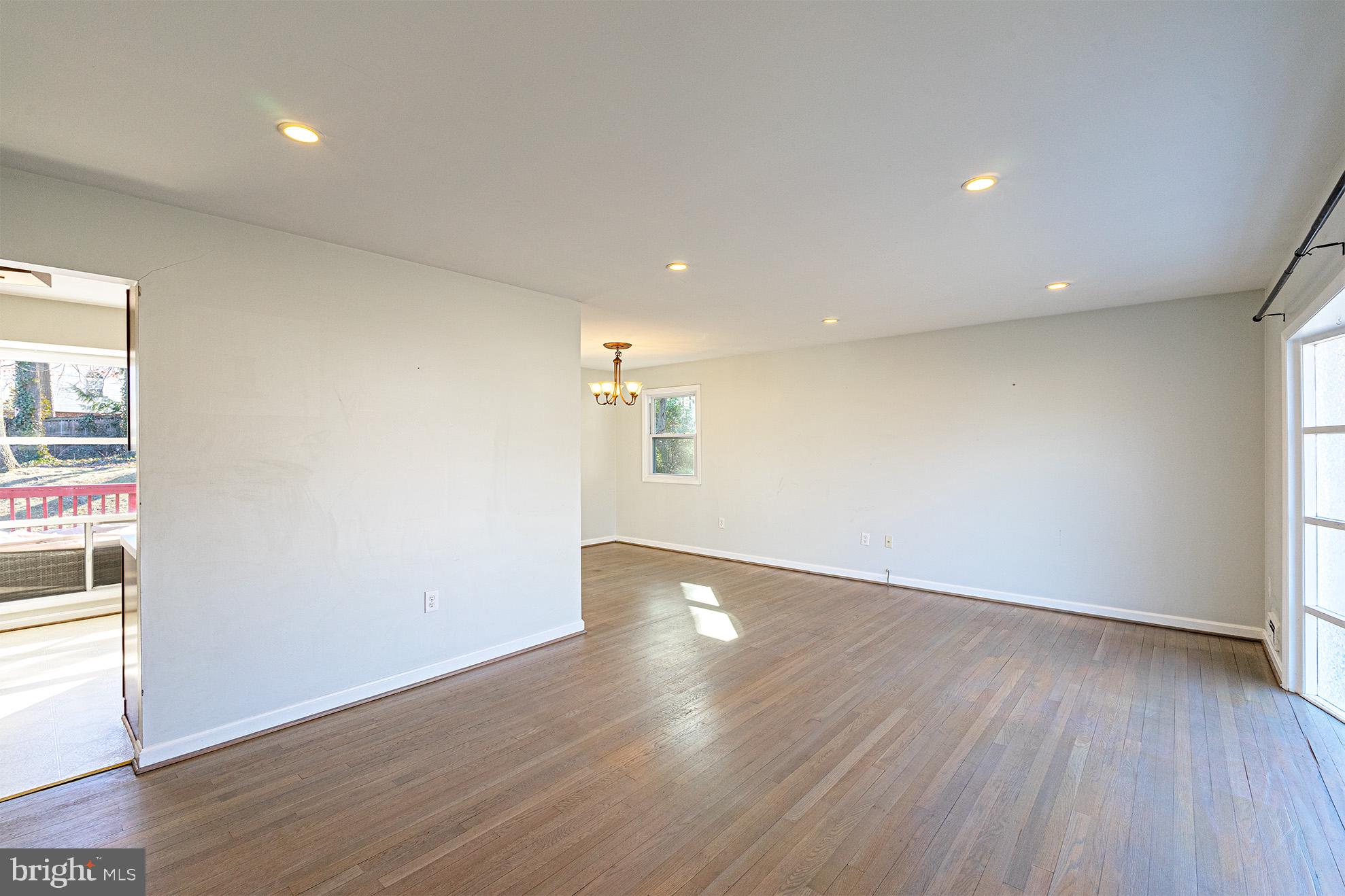 8207 Old Oaks Drive Springfield, VA 22152 - Photo 4 of 19 an empty room with wooden floor and windows