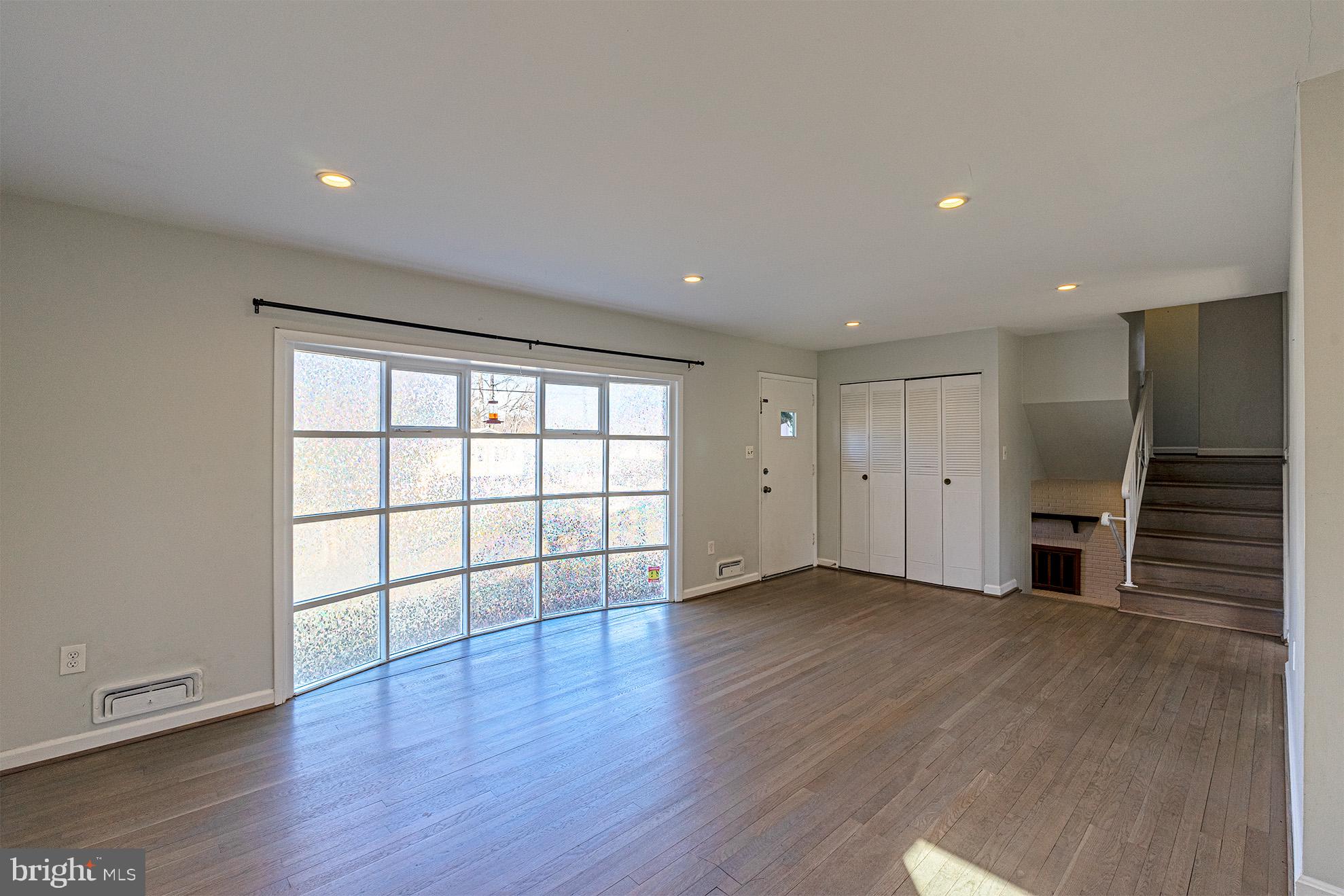 8207 Old Oaks Drive Springfield, VA 22152 - Photo 5 of 19 a view of an empty room with wooden floor and a window