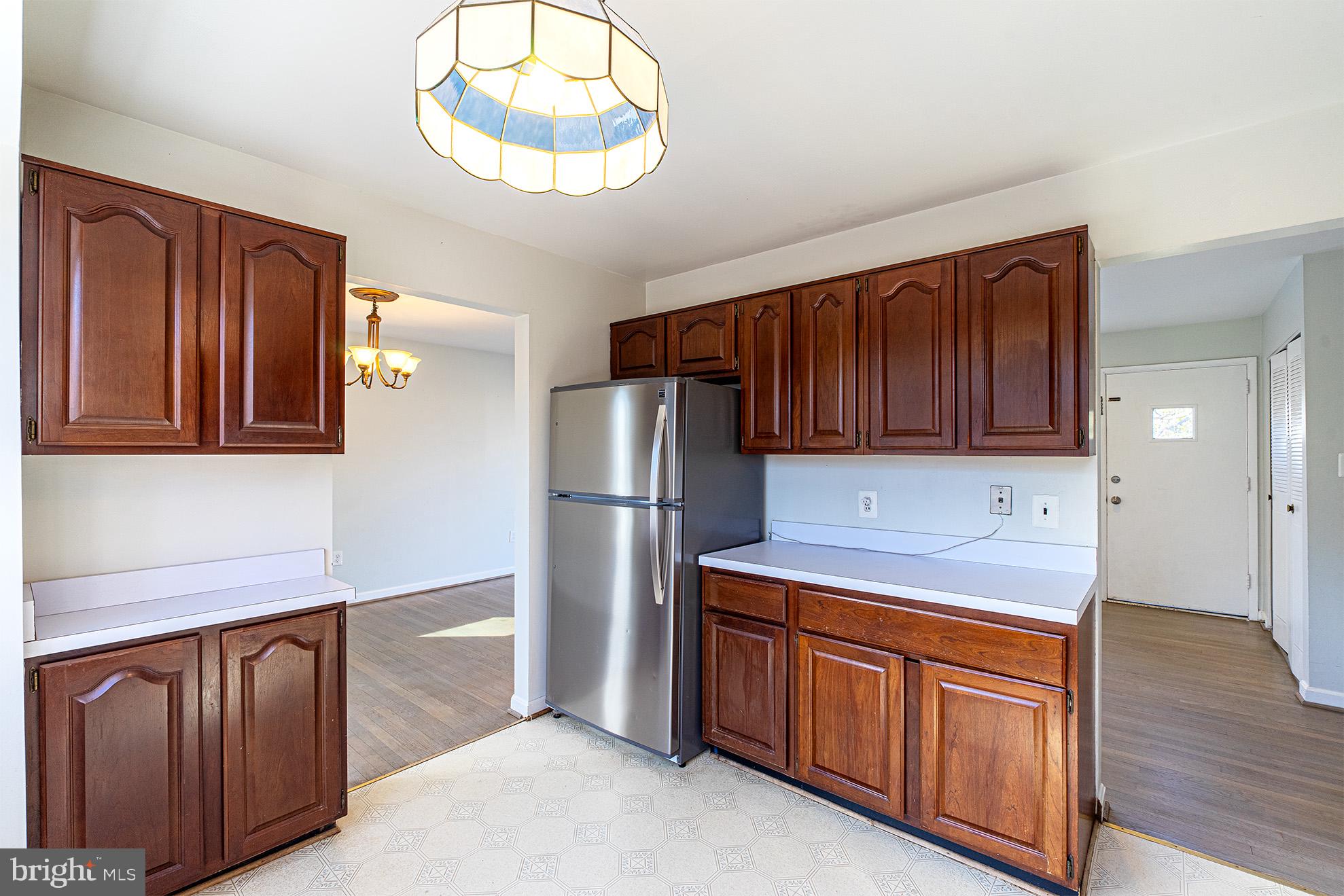 8207 Old Oaks Drive Springfield, VA 22152 - Photo 8 of 19 a kitchen with stainless steel appliances granite countertop wooden cabinets a stove a sink and dishwasher