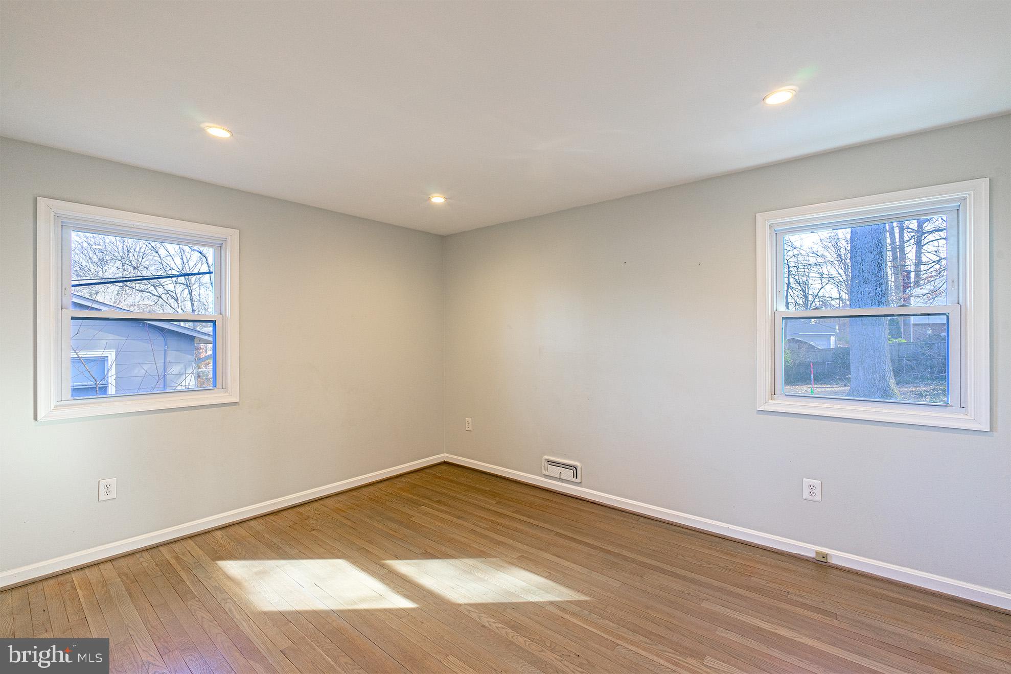 8207 Old Oaks Drive Springfield, VA 22152 - Photo 9 of 19 a view of empty room with wooden floor and fan