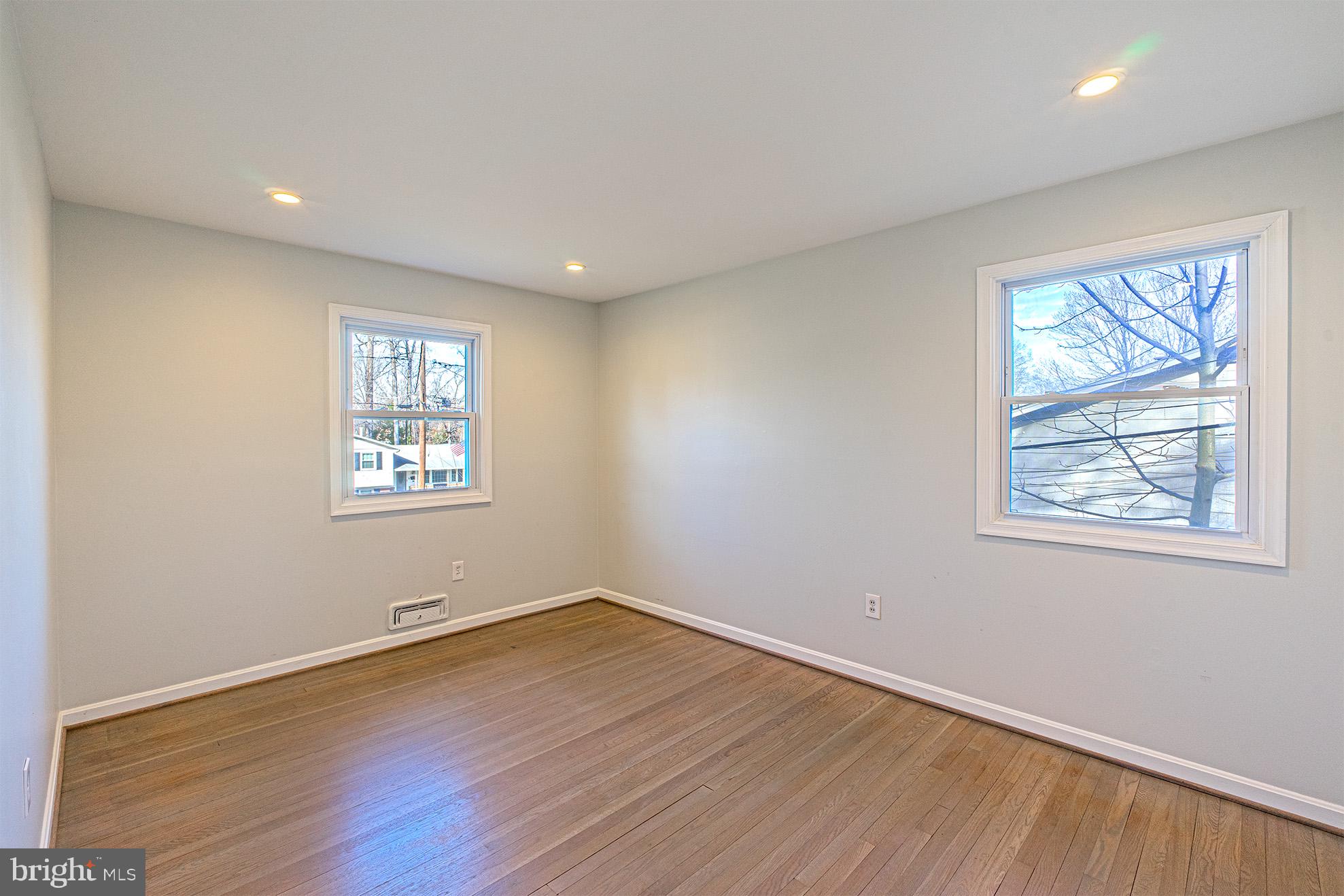 8207 Old Oaks Drive Springfield, VA 22152 - Photo 10 of 19 an empty room with wooden floor and windows