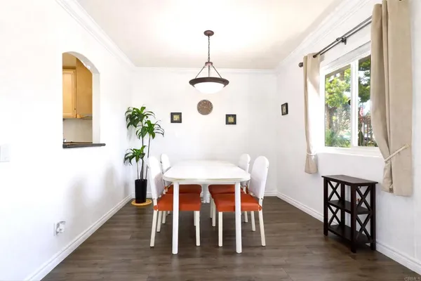a dining room with furniture window and wooden floor