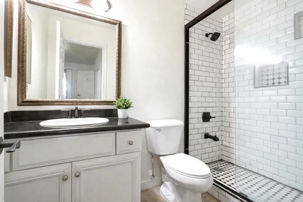 a bathroom with a toilet a sink and a mirror