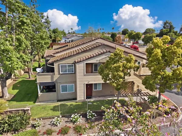 a view of a house with a yard and garden