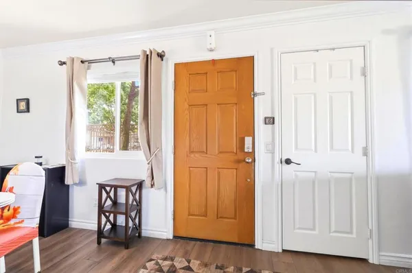 a view of a hallway with wooden floor and windows