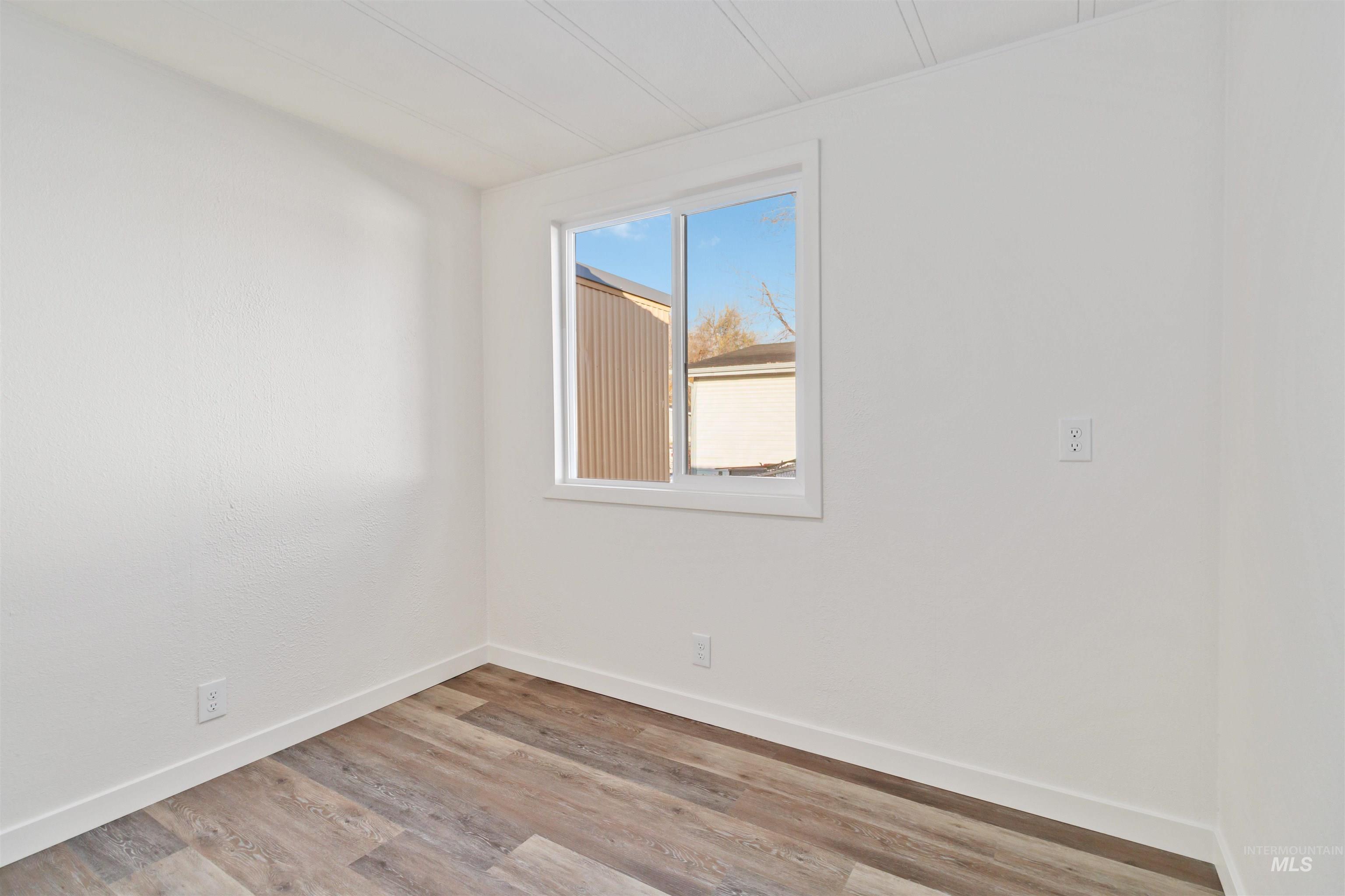 618 Empress Street Boise, ID 83713 - Photo 15 of 27 Spare room featuring light wood-style floors and baseboards