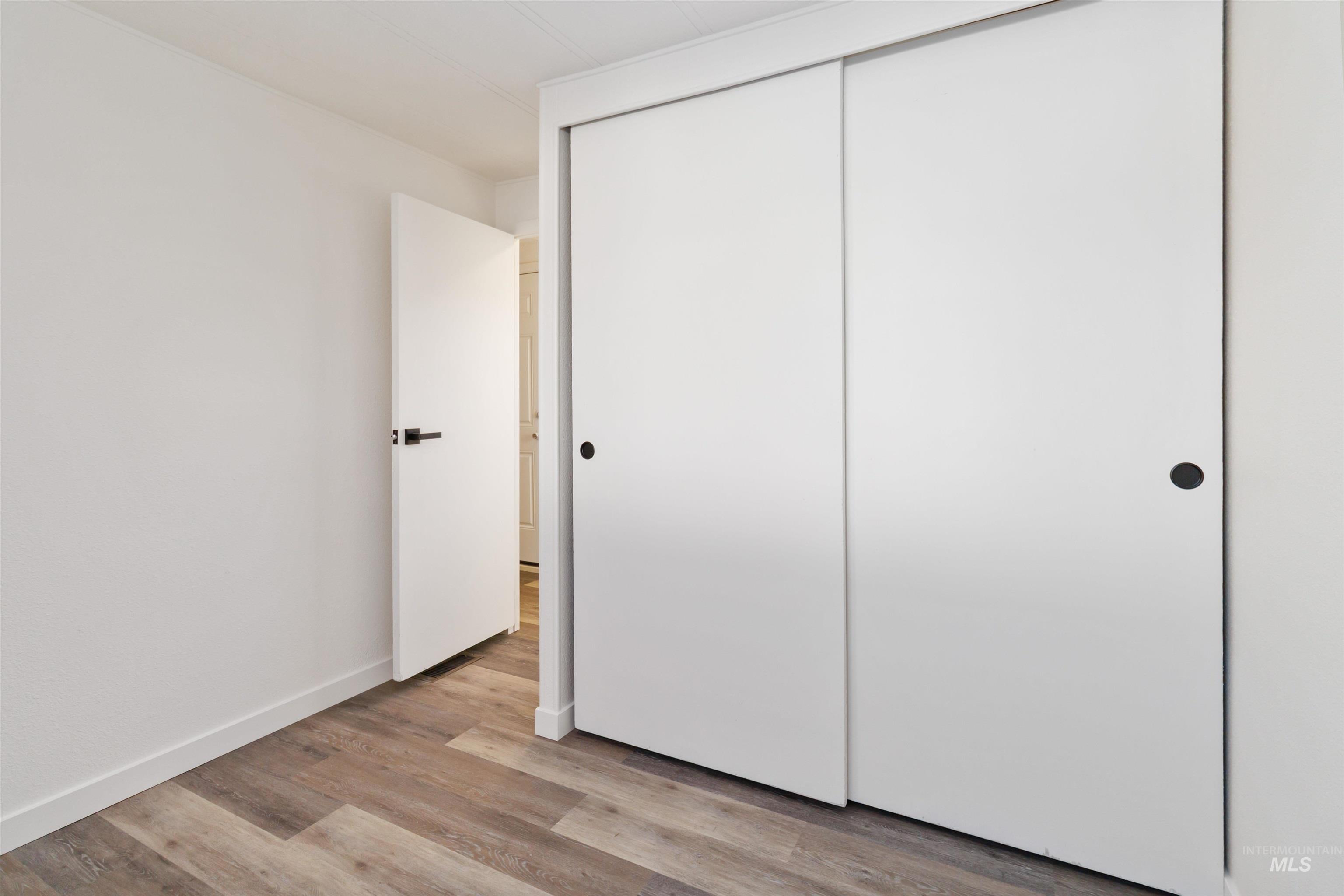 618 Empress Street Boise, ID 83713 - Photo 16 of 27 Unfurnished bedroom with light wood-style floors and a closet