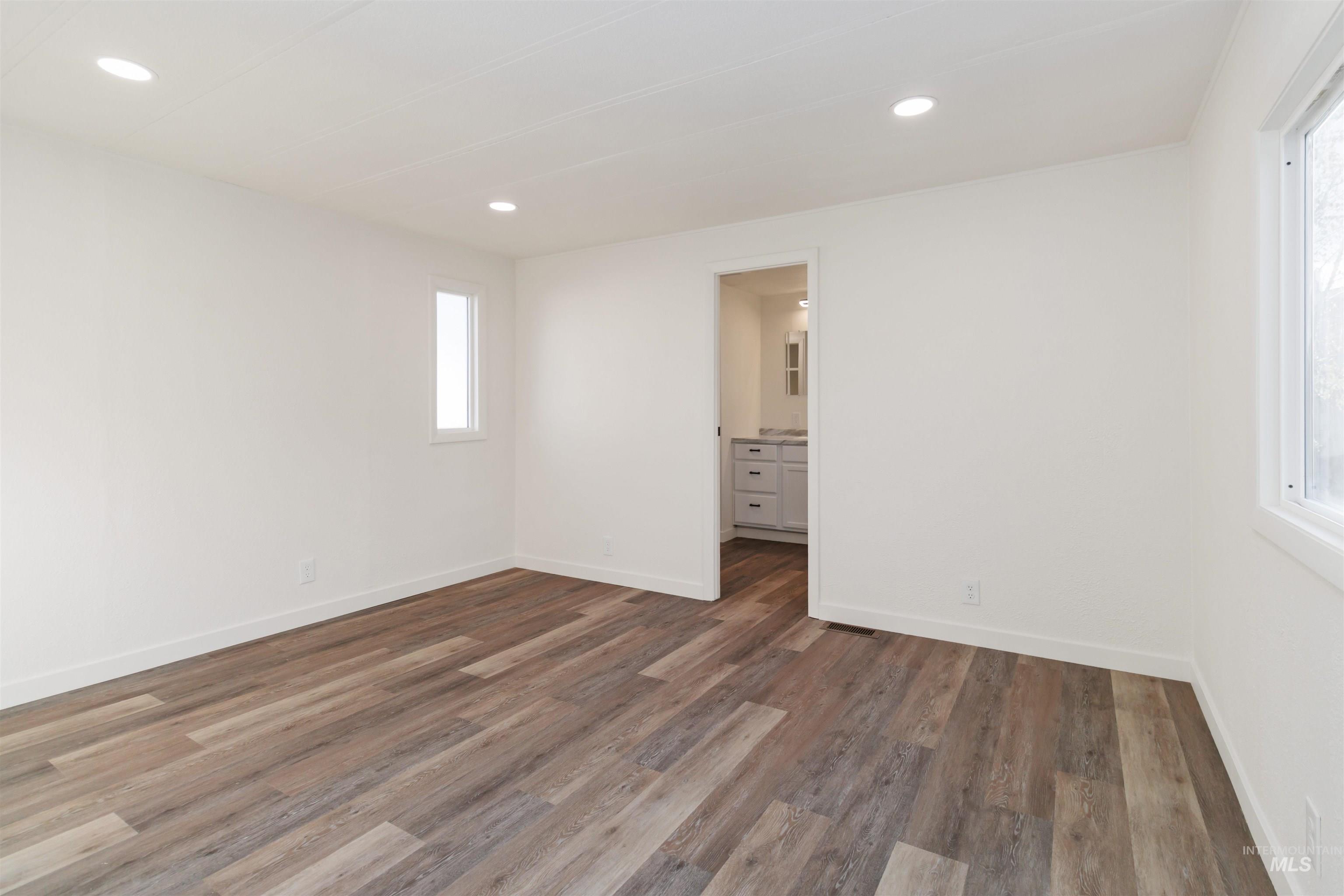 618 Empress Street Boise, ID 83713 - Photo 18 of 27 Unfurnished bedroom with dark wood-style floors, ensuite bathroom, and recessed lighting