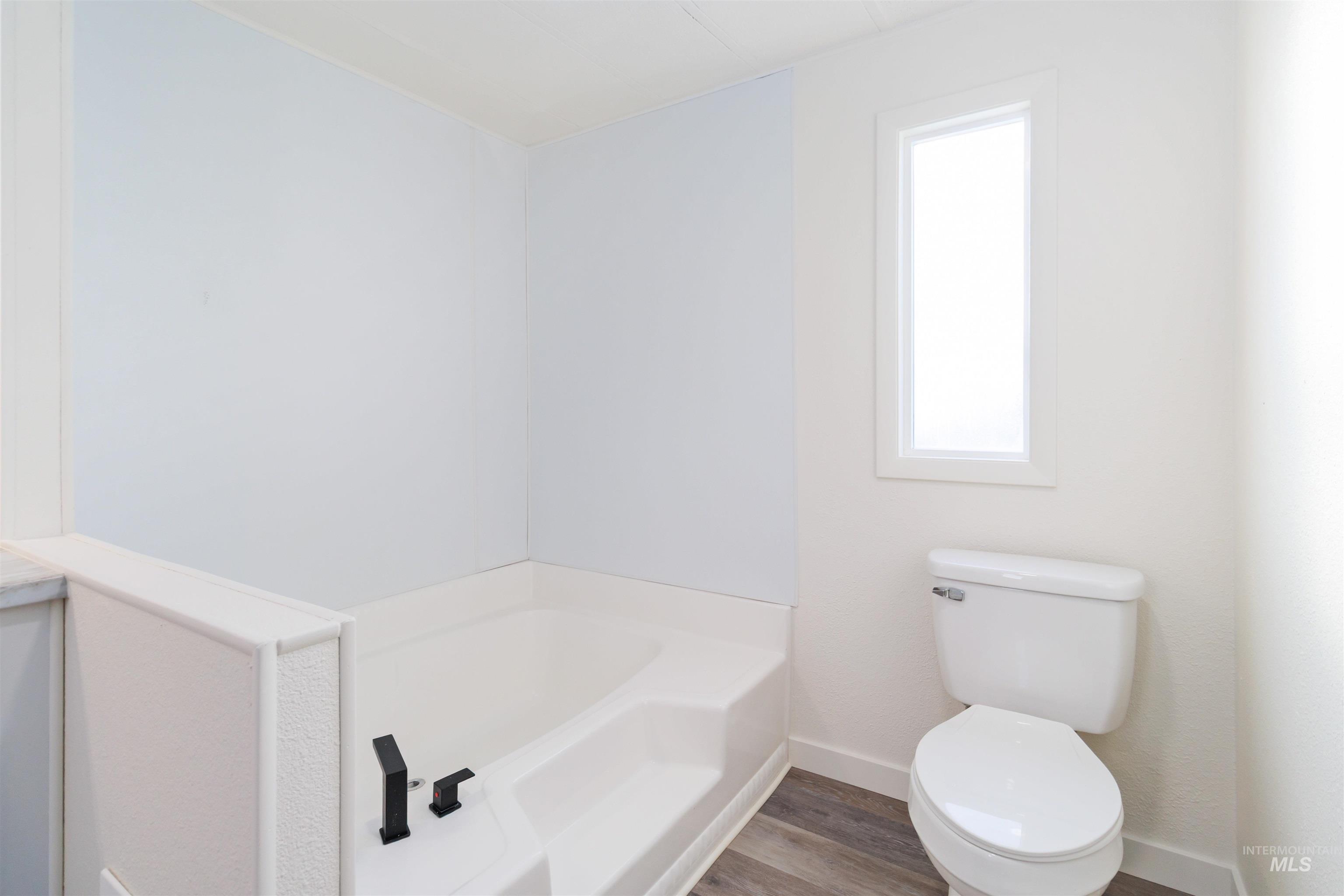 618 Empress Street Boise, ID 83713 - Photo 20 of 27 Bathroom with a garden tub and wood finished floors