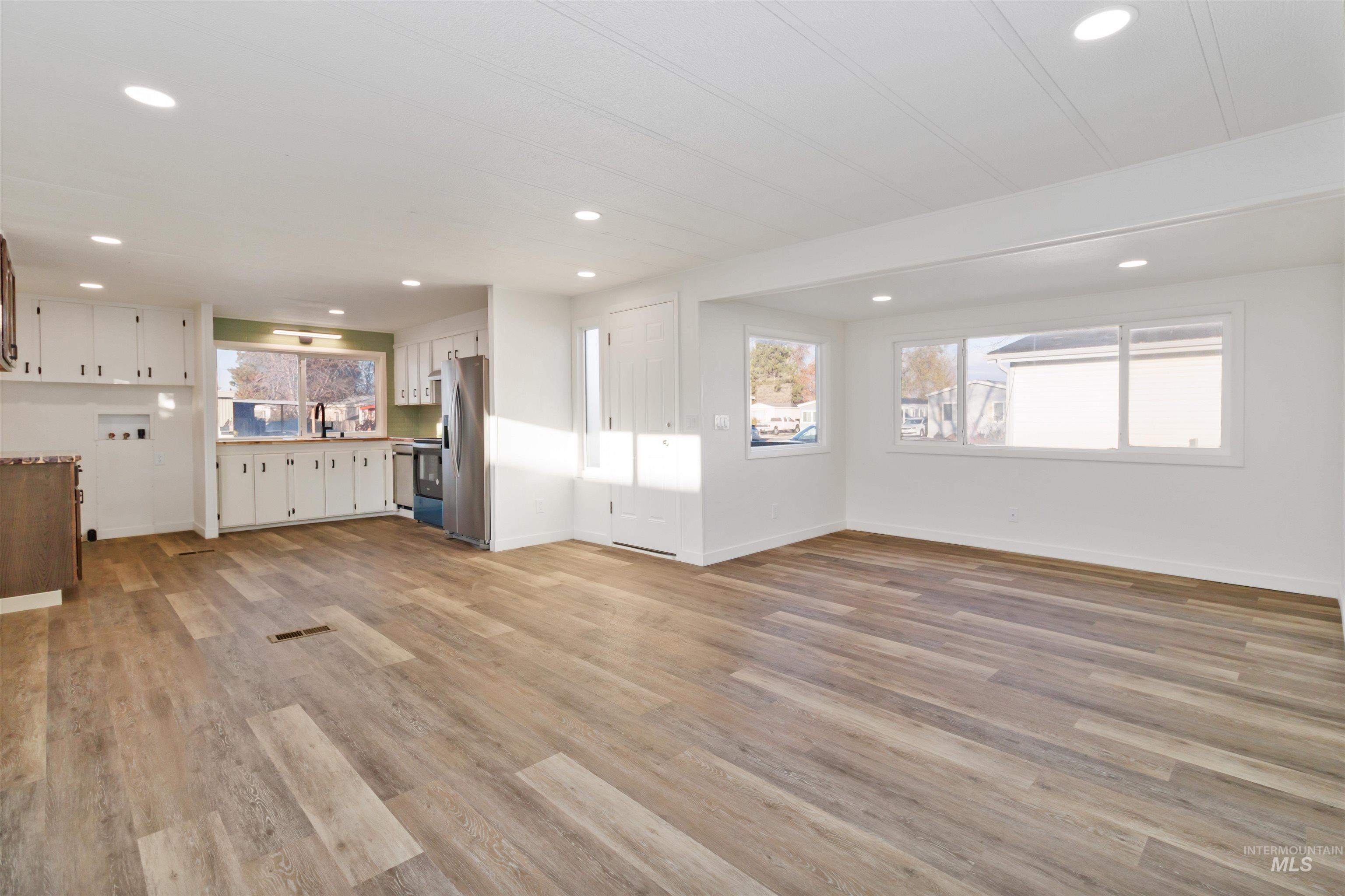 618 Empress Street Boise, ID 83713 - Photo 9 of 27 Unfurnished living room with light wood-style floors and recessed lighting
