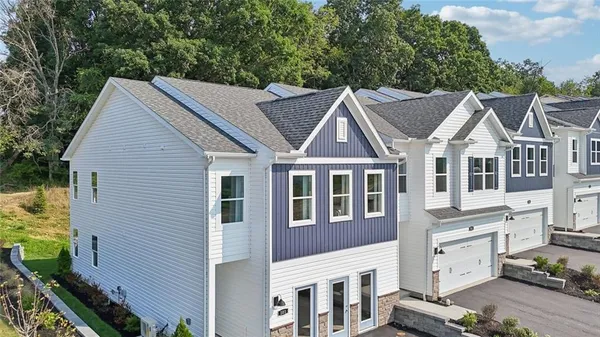 a aerial view of a house next to a yard