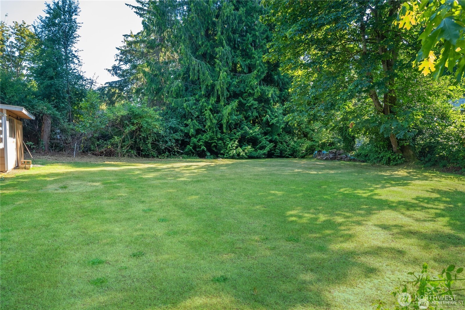 16621 188th Avenue Southeast, Unit 1&2 Renton, WA 98058 - Photo 4 of 5 a backyard of a house with lots of green space