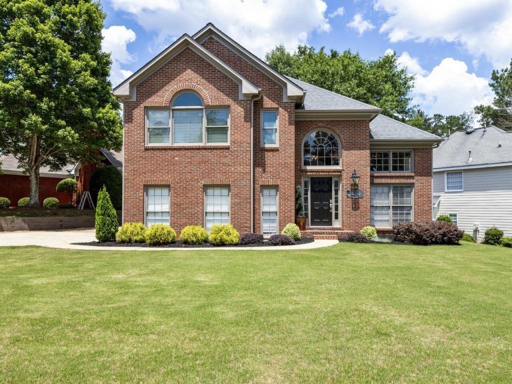 a front view of a house with a yard and garage