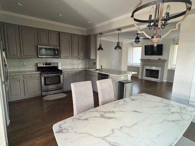 315 Landing Entry Alpharetta, GA 30022 - Photo 9 of 17 a kitchen with stainless steel appliances kitchen island granite countertop a stove a sink and a microwave