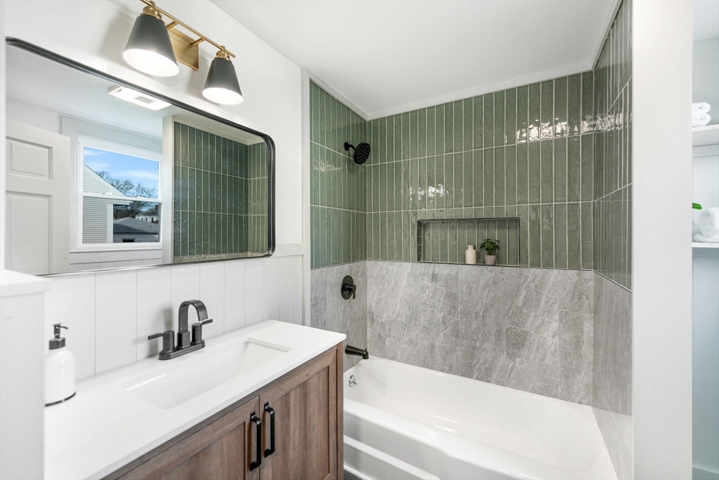 32 Cedar Street Fairhaven, MA 02719 - Photo 12 of 28 a bathroom with a tub sink and mirror
